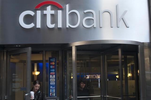 People exit a Citibank branch in New York, October 16, 2012. REUTERS/Keith Bedford
